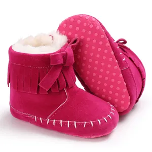 Detailed view of fuchsia fringe baby boots with faux fur lining and soft anti-slip soles