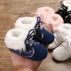 Detail view of cozy fur-lined baby walking boots with soft soles in navy blue