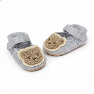 Detail view of grey baby walking shoes with cute plush bear design for 0-1 years