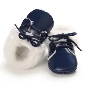 Close-up of navy blue baby fur boots with soft sole and white plush lining