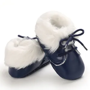 Detail view of navy blue baby winter boots featuring soft white faux fur lining