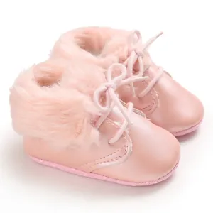 Detailed view of pink baby boots with soft faux fur lining and lace-up design