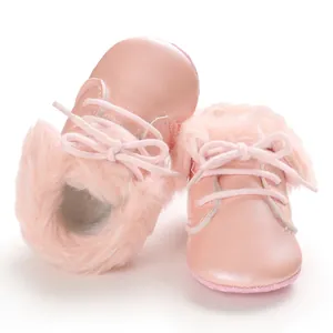 Close-up detail showing the soft pink fur lining and leather texture of baby walking boots