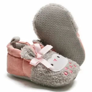 Detailed view of soft fleece baby shoes with cute cartoon face and non-slip sole.
