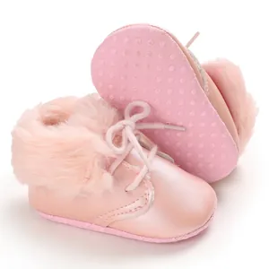 Detailed view of pink baby fur boots with soft anti-slip soles and warm faux fur trim.