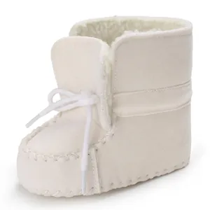 Macro view of cream white fleece-lined baby boots featuring soft soles and tied laces