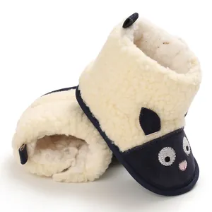 Gros plan détaillé sur la broderie chat mignon de bottes d'hiver polaires pour bébé.