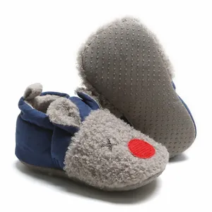 Detail showing the soft non-slip sole and warm plush fabric of cartoon baby booties