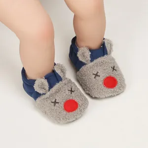 Detailed view of warm cartoon baby walking shoes with soft soles for indoor winter use
