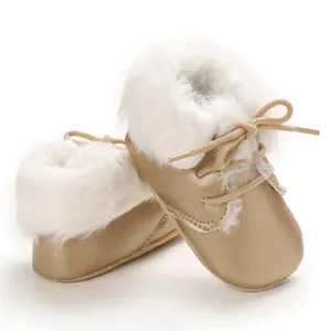 Close-up of golden baby boots featuring plush white faux fur lining and soft soles