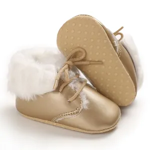 Detailed view of warm gold baby boots with soft faux fur lining and anti-slip sole