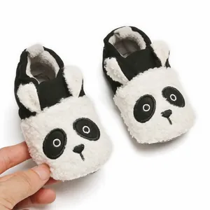 Close-up view of cute panda themed plush baby shoes with soft soles for winter warmth