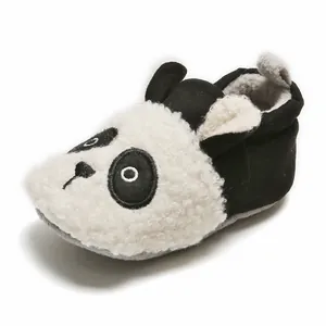 Close-up of panda-themed baby winter shoe with soft plush texture and non-slip sole.