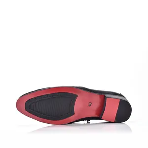 Detailed macro view of the stylish red and black anti-slip sole on men's leather dress shoes