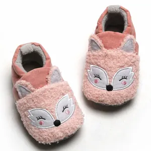 Detailed view of soft pink baby booties with cute embroidered fox face for winter warmth