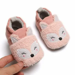 Close-up detail of pink plush baby fox slippers featuring soft warm lining and non-slip sole