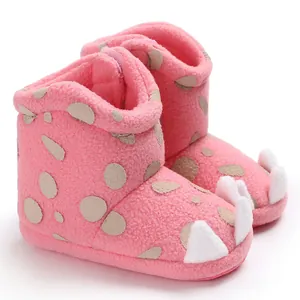 Close-up of pink baby winter boots with soft coral fleece and decorative claws