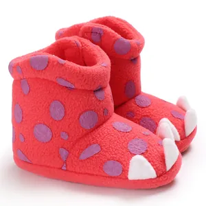 Detailed view of red plush baby boots with purple polka dots and white claws