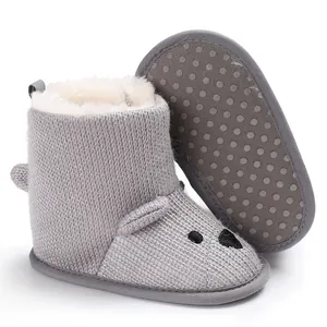 Detail der grauen Strick-Babystiefel mit weichem Plüschfutter und rutschfester Sohle.