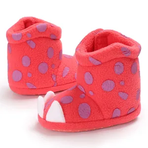 Detailed view of red plush infant snow boots with cute claw design and soft sole