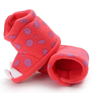 Detailed view of red fleece baby claw booties with purple polka dots and soft warm lining