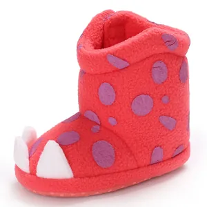 Close-up of red baby winter boots with cute white claw design and soft sole