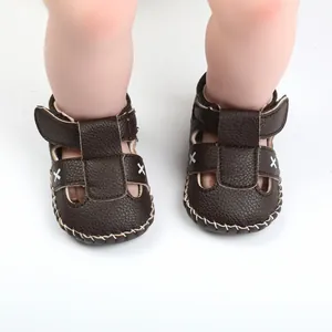 Brown faux leather baby sandals with white cross stitching for infants 0-1 year old.