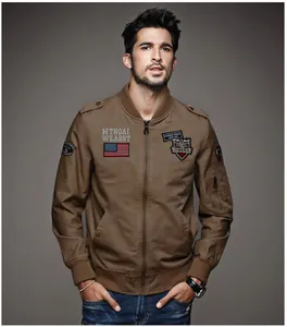 Detailed front view of a brown cotton bomber jacket with vintage flight patches and badges.