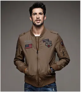 Front view of a brown men's cotton flight jacket with decorative patches on model