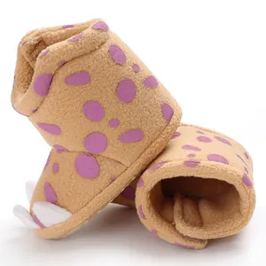 Close-up detail of warm winter fleece baby snow boots with dots and claw design