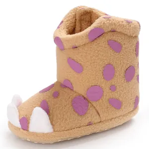 Close-up of baby monster paw winter boots with soft fleece texture and purple spots