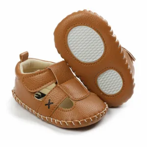 Detail view of brown leather-textured baby walker sandals with non-slip soft soles.