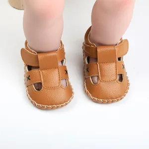 Detail view of brown baby walking sandals with velcro straps and stitching