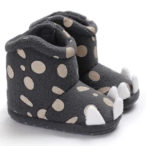 Detailed view of baby winter plush boots featuring cute 3D claw design and polka dots