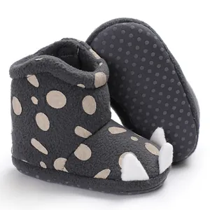 Detail view of warm fleece baby booties with cute claw design and soft sole