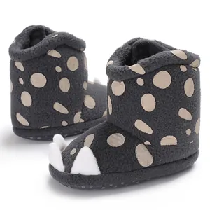 Detailed view of grey baby winter boots with cute white claw design and polka dots