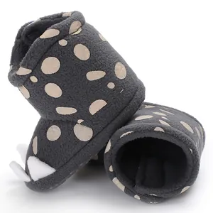 Close-up of baby warm boots featuring a dark grey fleece with cute polka dot patterns.