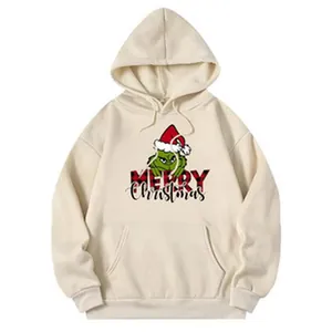 Vue détaillée d'un sweat à capuche oversize crème avec imprimé Grinch et Joyeux Noël