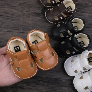 Close-up of soft faux leather baby sandals in various colors with X embroidery detail.