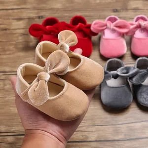 Detailed shot of soft velvet baby walking shoes featuring a large velvet bow
