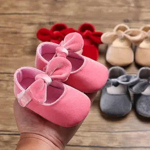 Detailed view of soft velvet baby Mary Jane shoes with decorative bow in pink color.
