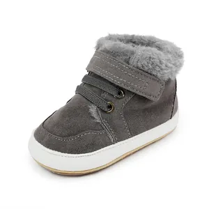 Nahaufnahme eines grauen Winter-Lauflernschuhs für Babys mit warmem Pelzfutter und Klett