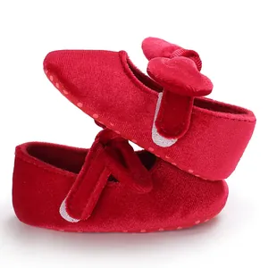 Detailed view of red velvet baby princess walker shoes with bow and soft non-slip sole.