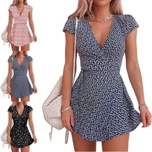 A detail view of the floral wrap mini dress available in navy, pink, blue, and black.