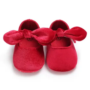 Top view showing soft red velvet texture and bow detail of baby pre-walker shoes