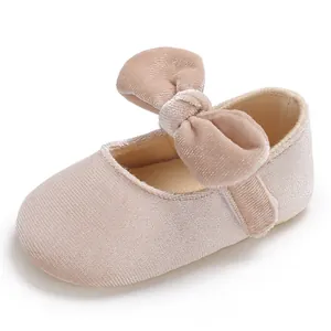 Detail view of baby girl's pink velvet Mary Jane walking shoe featuring a large bow