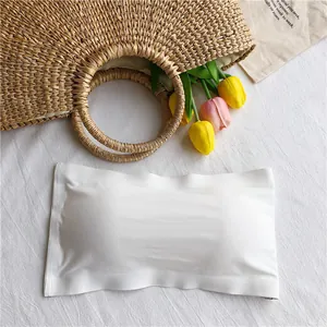 Seamless white ice silk strapless bandeau bra shown with summer props background
