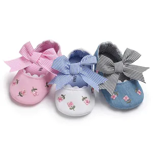 Vue détaillée de chaussures de princesse souples pour bébé en rose, blanc et bleu brodé.