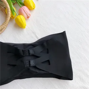 Detail showing back closure hooks and hollow-out design of a black ice silk bandeau