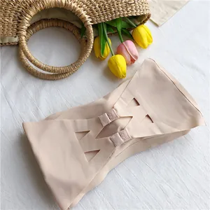 Detailed view of the nude seamless strapless bandeau bra with back hook closure